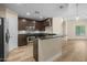 This modern kitchen features stainless steel appliances, granite countertops, and dark cabinetry at 945 E Playa Del Norte Dr # 1022, Tempe, AZ 85288