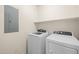 Well-lit laundry room with modern washer and dryer and storage shelf at 945 E Playa Del Norte Dr # 1022, Tempe, AZ 85288