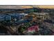Aerial view of neighborhood restaurants and office buildings with city skyline at dusk at 945 E Playa Del Norte Dr # 1022, Tempe, AZ 85288