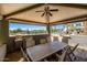 Outdoor patio with a dining area, outdoor kitchen, and a view of the pool on a sunny day at 945 E Playa Del Norte Dr # 1022, Tempe, AZ 85288