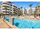 Refreshing pool area with spa, outdoor fireplace, and palm trees at 945 E Playa Del Norte Dr # 1022, Tempe, AZ 85288