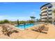Outdoor pool features lounge chairs, shade umbrellas and tropical landscaping at 945 E Playa Del Norte Dr # 1022, Tempe, AZ 85288