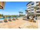Pool and lounge area featuring outdoor fireplace, grill, and palm trees at 945 E Playa Del Norte Dr # 1022, Tempe, AZ 85288