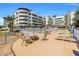 Resort-style pool area with lounge chairs, tables, palm trees, and views of the surrounding buildings at 945 E Playa Del Norte Dr # 1022, Tempe, AZ 85288
