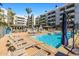 Outdoor pool with lounge chairs, covered bar, fireplace and umbrellas at 945 E Playa Del Norte Dr # 1022, Tempe, AZ 85288