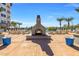 Outdoor pool area with fireplace, seating, landscaping, and grill at 945 E Playa Del Norte Dr # 1022, Tempe, AZ 85288