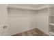 Spacious walk-in closet with built-in shelving and wood-look flooring at 945 E Playa Del Norte Dr # 1022, Tempe, AZ 85288