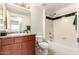 A bathroom features a shower-tub combo, tile, vanity, and adjacent commode for convenience at 9820 N Central Ave # 307, Phoenix, AZ 85020