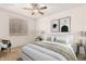 A staged bedroom with carpet, a ceiling fan, and art on the wall at 9820 N Central Ave # 307, Phoenix, AZ 85020