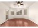 Spacious room with updated ceiling fan, wood floors, and access to a balcony at 9820 N Central Ave # 307, Phoenix, AZ 85020