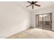 A bedroom with a ceiling fan and a sliding door to a balcony at 9820 N Central Ave # 307, Phoenix, AZ 85020