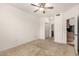 A bedroom with carpet and an open door to a bathroom at 9820 N Central Ave # 307, Phoenix, AZ 85020
