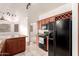A kitchen with cherry-toned wood cabinets, stainless steel appliances, and an island at 9820 N Central Ave # 307, Phoenix, AZ 85020