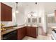 Kitchen view highlighting granite countertops, appliances, and access to the living room at 9820 N Central Ave # 307, Phoenix, AZ 85020