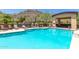 Community swimming pool and lounge area with mountain views, perfect for relaxing and enjoying the Arizona sunshine at 9820 N Central Ave # 307, Phoenix, AZ 85020