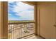 View from balcony with iron railing overlooking the city, parking, and distant mountains at 9820 N Central Ave # 324, Phoenix, AZ 85020