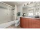Bathroom with a shower-tub combo, white toilet, neutral walls, and large single sink vanity at 9820 N Central Ave # 324, Phoenix, AZ 85020