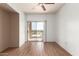 Bedroom featuring hardwood floors, neutral walls, and sliding doors leading to a balcony at 9820 N Central Ave # 324, Phoenix, AZ 85020