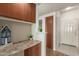 Inviting entryway with tiled floor, built-in desk, storage cabinets, and a view of the front door at 9820 N Central Ave # 324, Phoenix, AZ 85020