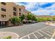 View of the apartment building exterior, with some trees and parking at 9820 N Central Ave # 324, Phoenix, AZ 85020