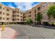 Apartment complex exterior with parking, landscaping, and a blue sky above at 9820 N Central Ave # 324, Phoenix, AZ 85020