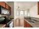 Open concept kitchen with a view of the living area featuring lots of windows and natural light at 9820 N Central Ave # 324, Phoenix, AZ 85020