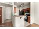 Modern kitchen featuring an island, black appliances, and a view to the entryway at 9820 N Central Ave # 324, Phoenix, AZ 85020