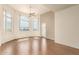 Spacious living room with hardwood floors, large windows, and a ceiling fan, offering ample natural light at 9820 N Central Ave # 324, Phoenix, AZ 85020