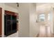 Open-concept living space featuring modern flooring, natural light, and view into an adjacent modern kitchen at 9820 N Central Ave # 324, Phoenix, AZ 85020