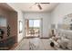Comfortable and staged main bedroom featuring hardwood floors and sliding doors leading to a balcony at 9820 N Central Ave # 324, Phoenix, AZ 85020