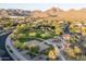 Aerial view of a community park, playground and picnic area surrounded by mountain views at 9865 E Piedra Dr, Scottsdale, AZ 85255