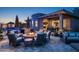 Luxurious backyard with fire pit, cozy seating, pool, and covered patio for entertaining at 9865 E Piedra Dr, Scottsdale, AZ 85255