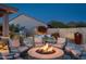 Inviting outdoor living space with a cozy fire pit, comfortable seating, and lush landscaping at 9865 E Piedra Dr, Scottsdale, AZ 85255