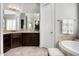Bathroom boasts dark wood cabinets, mosaic tile backsplash, and separate tub area with tile surround at 9865 E Piedra Dr, Scottsdale, AZ 85255