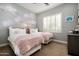 Comfortable bedroom with two twin beds, floral wallpaper, and a shuttered window at 9865 E Piedra Dr, Scottsdale, AZ 85255