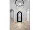 Elegant foyer featuring arched doorways, a decorative chandelier, and tiled flooring, creating a grand entrance at 9865 E Piedra Dr, Scottsdale, AZ 85255