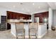 A kitchen featuring stainless steel appliances, granite countertops, a wine cooler, and dark wood cabinets at 9865 E Piedra Dr, Scottsdale, AZ 85255