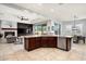 An open concept kitchen featuring stainless steel appliances, granite countertops, and dark wood cabinetry at 9865 E Piedra Dr, Scottsdale, AZ 85255