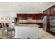 Well-equipped kitchen with stainless steel appliances, granite countertops, and ample cabinet space at 9865 E Piedra Dr, Scottsdale, AZ 85255