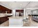 A spacious kitchen featuring stainless steel appliances, granite countertops, and dark wood cabinetry at 9865 E Piedra Dr, Scottsdale, AZ 85255