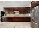 A kitchen featuring stainless steel appliances, granite countertops, and dark wood cabinets at 9865 E Piedra Dr, Scottsdale, AZ 85255