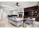 Open living space featuring a fireplace, built-in shelving, comfortable seating, and a formal dining area at 9865 E Piedra Dr, Scottsdale, AZ 85255