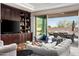 An open living room with a large sliding glass door and a custom built-in entertainment center at 9865 E Piedra Dr, Scottsdale, AZ 85255