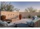 Inviting outdoor living area with custom seating, desert landscaping, and stone-clad water feature at 9865 E Piedra Dr, Scottsdale, AZ 85255