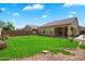 An ample lawn is accompanied by a covered porch and desert landscaping at 10152 E Knowles Ave, Mesa, AZ 85209