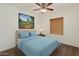Bright bedroom featuring a ceiling fan, neutral walls, and a comfortable bed with light blue bedding at 10152 E Knowles Ave, Mesa, AZ 85209