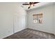 A carpeted bedroom featuring a window, ceiling fan and bi-fold closet at 10152 E Knowles Ave, Mesa, AZ 85209