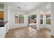 Cozy dining area with tile floors, modern lighting, and a sliding glass door to the backyard at 10152 E Knowles Ave, Mesa, AZ 85209