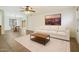 Inviting living room features neutral tones, a ceiling fan, and leads into the dining area at 10152 E Knowles Ave, Mesa, AZ 85209