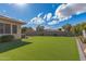 Expansive artificial turf backyard offers a pristine and low-maintenance outdoor space for relaxation and recreation at 104 E Louis Way, Tempe, AZ 85284